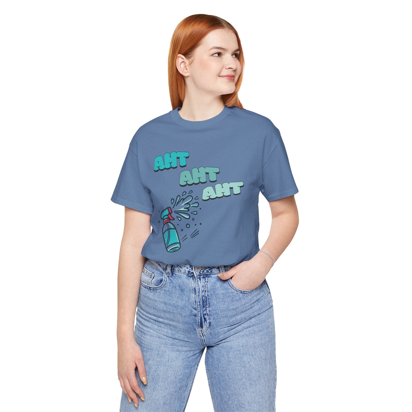 a woman wearing a spray bottle shooting three squirts of water, each squirt accompanied by the playful text 'Aht Aht Aht.' The design is printed on a heather blue T-shirt, adding a humorous and cheeky vibe, perfect for warding off unwanted behavior with a lighthearted message.