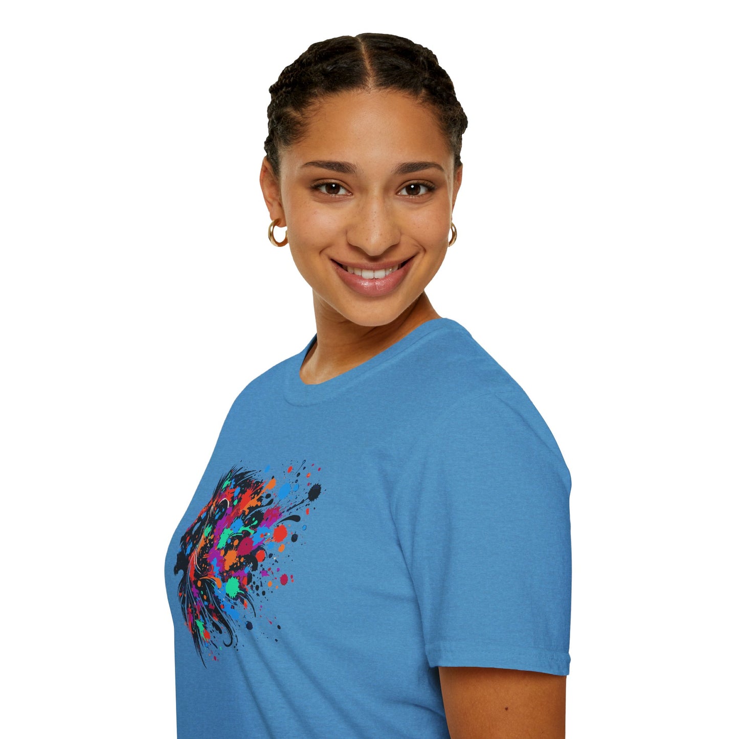a woman wearing a heather sapphire colored tshirt background featuring a vibrant ink splatter forming the side profile of a lion's head, showcasing bold colors and dynamic artistic detail.