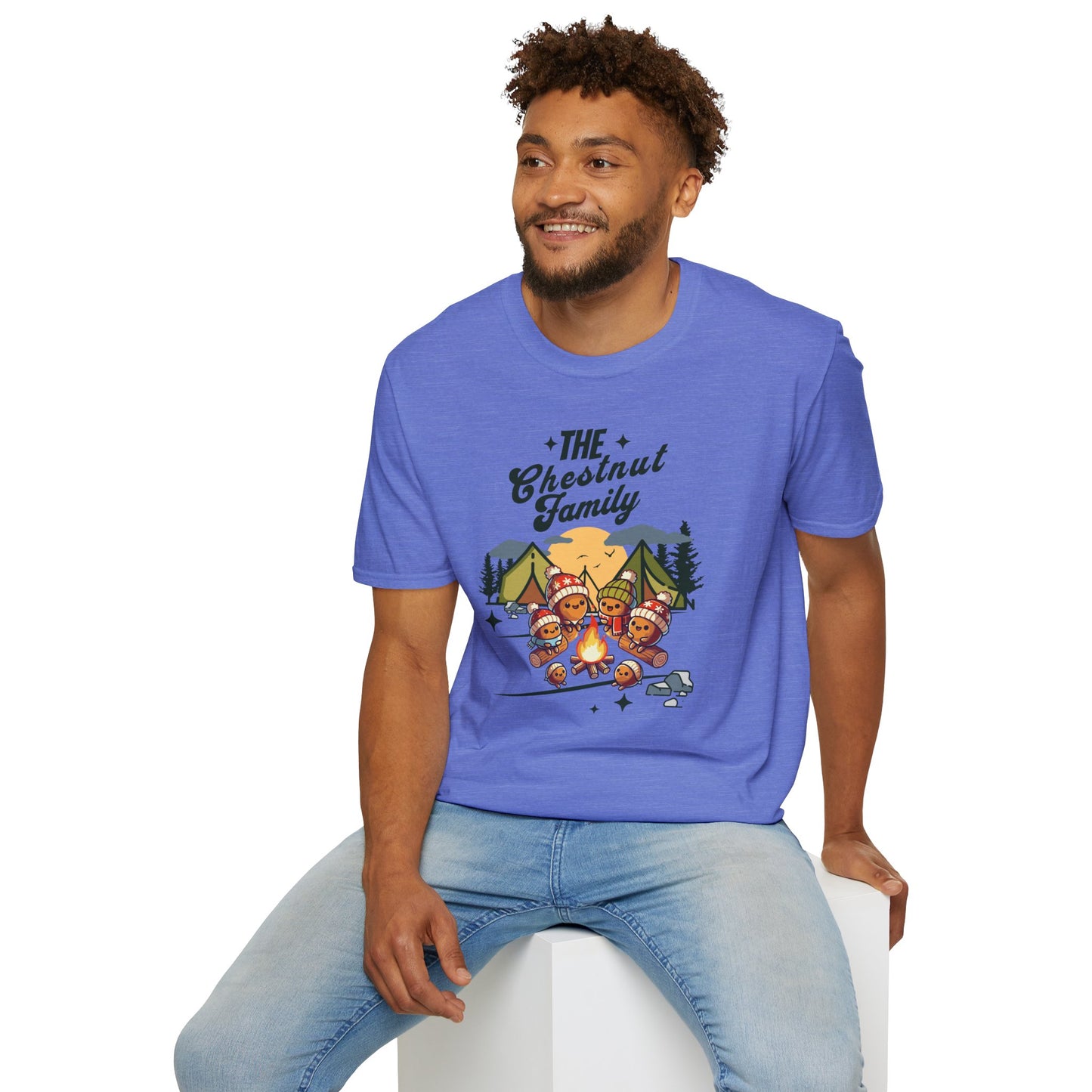 a man wearing a heather royal colored t-shirt with an image of a cartoon family of chestnuts sitting by an open fire at a campsite