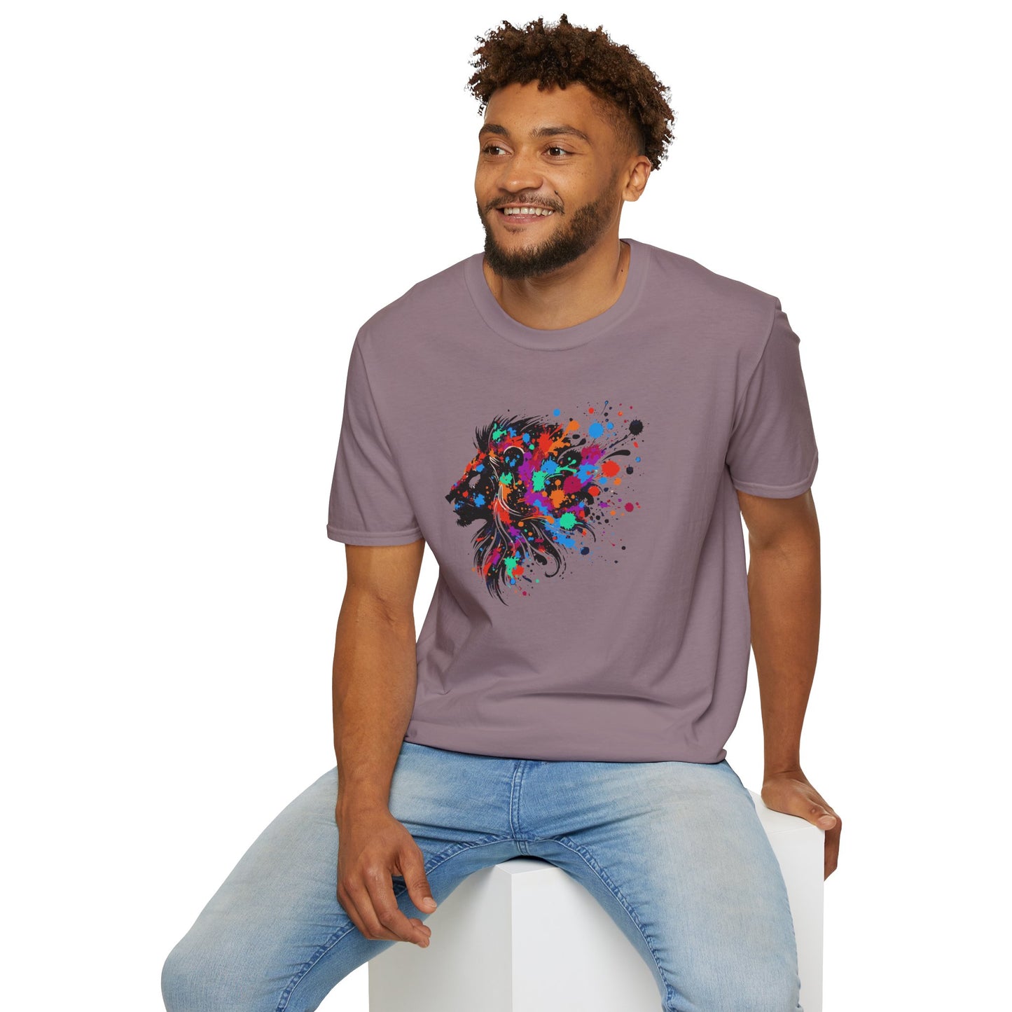 a man wearing a paragon colored tshirt background featuring a vibrant ink splatter forming the side profile of a lion's head, showcasing bold colors and dynamic artistic detail.