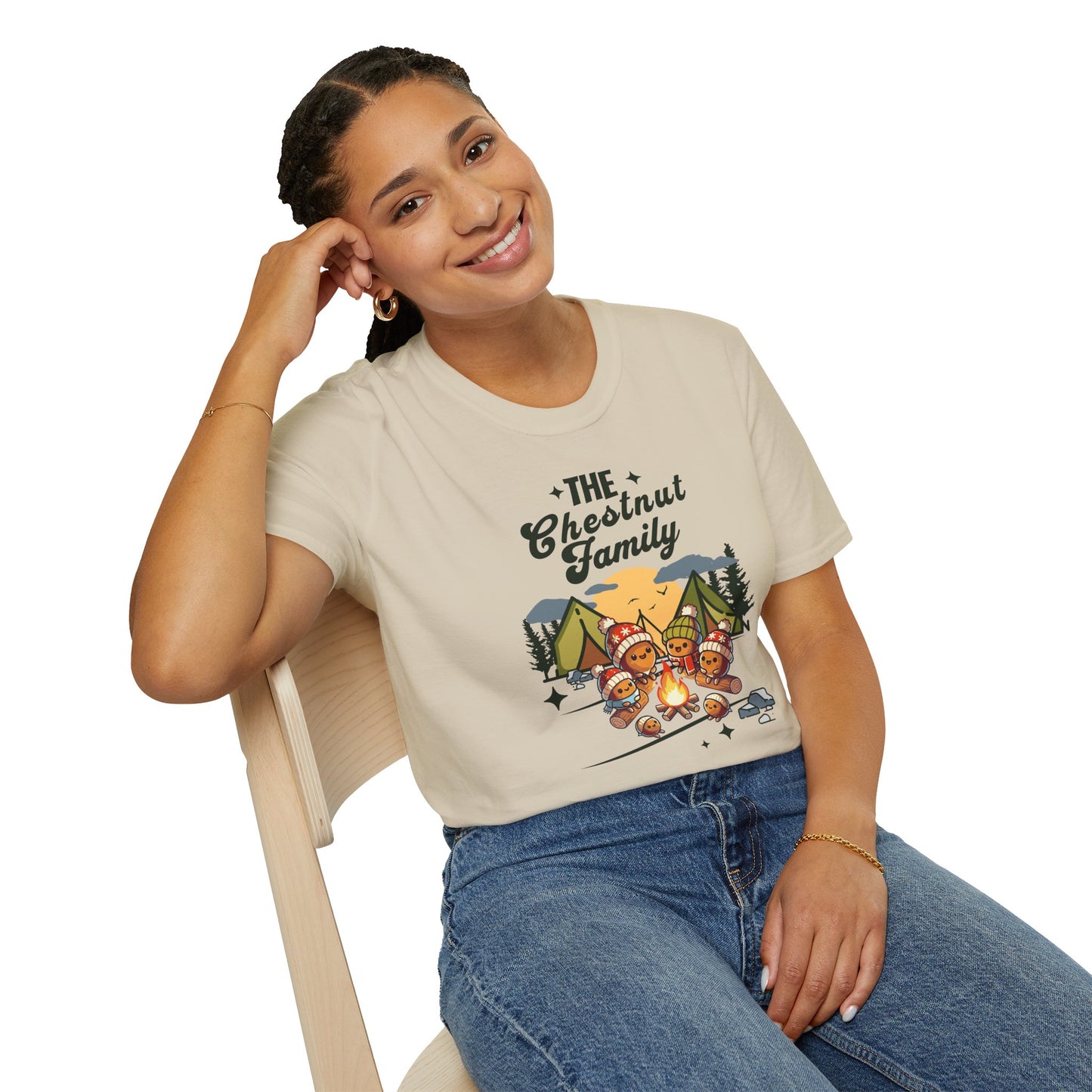 a woman wearing a sand colored t-shirt with an image of a cartoon family of chestnuts sitting by an open fire at a campsite