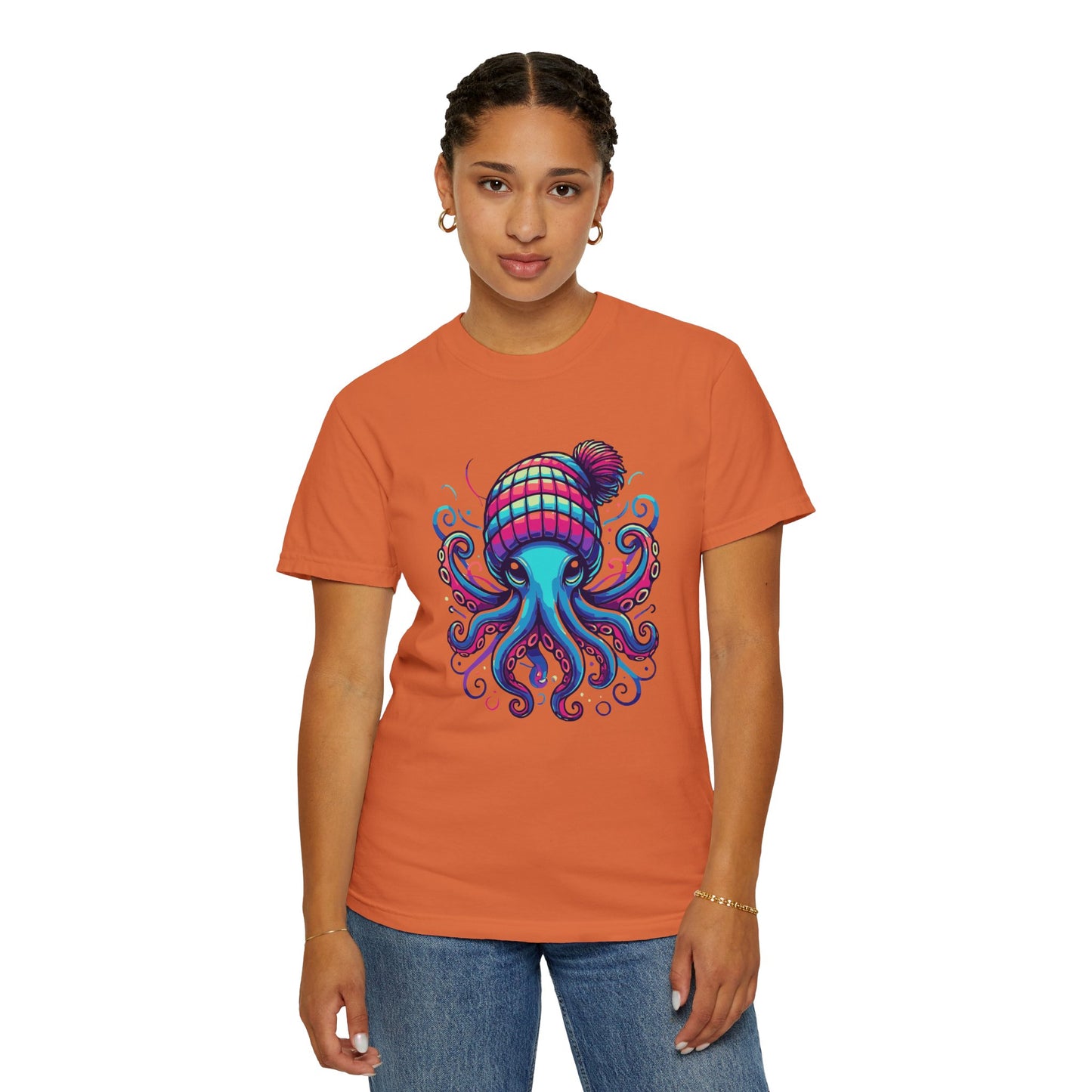 a woman wearing a burnt orange colored t-shirt with an image of jewel-toned Octopus wearing a knit cap