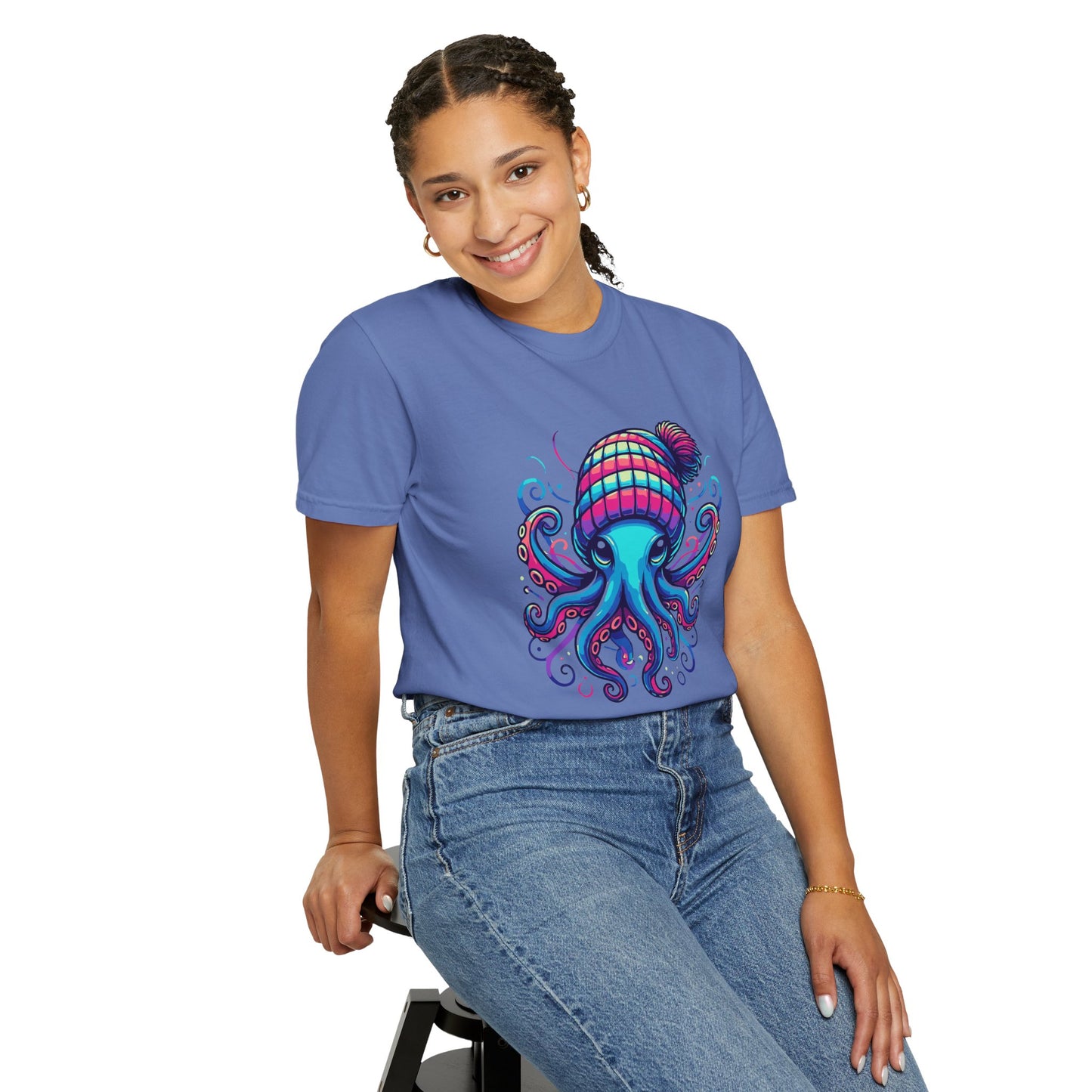 a woman wearing a mystic blue colored t-shirt with an image of jewel-toned octopus wearing a knit cap