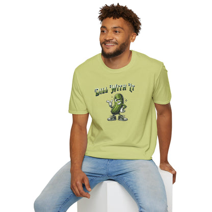 a man wearing a pistachio colored t-shirt featuring a snarky pickle with a smirking expression, accompanied by the text 'Dill with it.' The pickle exudes cool confidence, perfect for those who embrace their individuality and unbothered attitude.