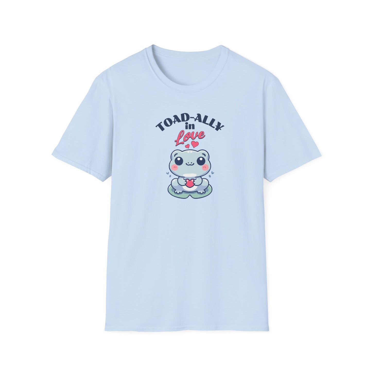  a cartoonish blue frog with a cheerful expression holds a small red heart in its hands. The design is printed on a light blue T-shirt and features the playful phrase 'Leap into Love!' adding a charming and romantic vibe.