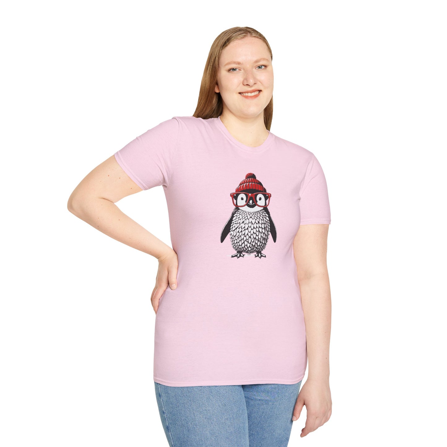 a woman wearing a light pink colored t-shirt with an image of a penguin wearing a red beanie and red eyeglasses