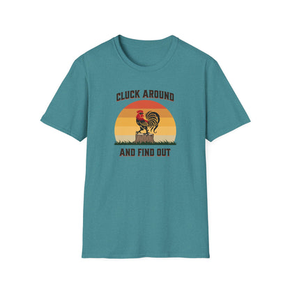 Heather Galapagos blue colored  t-shirt featuring a red and black rooster standing on a brown tree stump on green grass, set against a retro red-to-orange sunset background with the text 'Cluck Around and Find Out'.