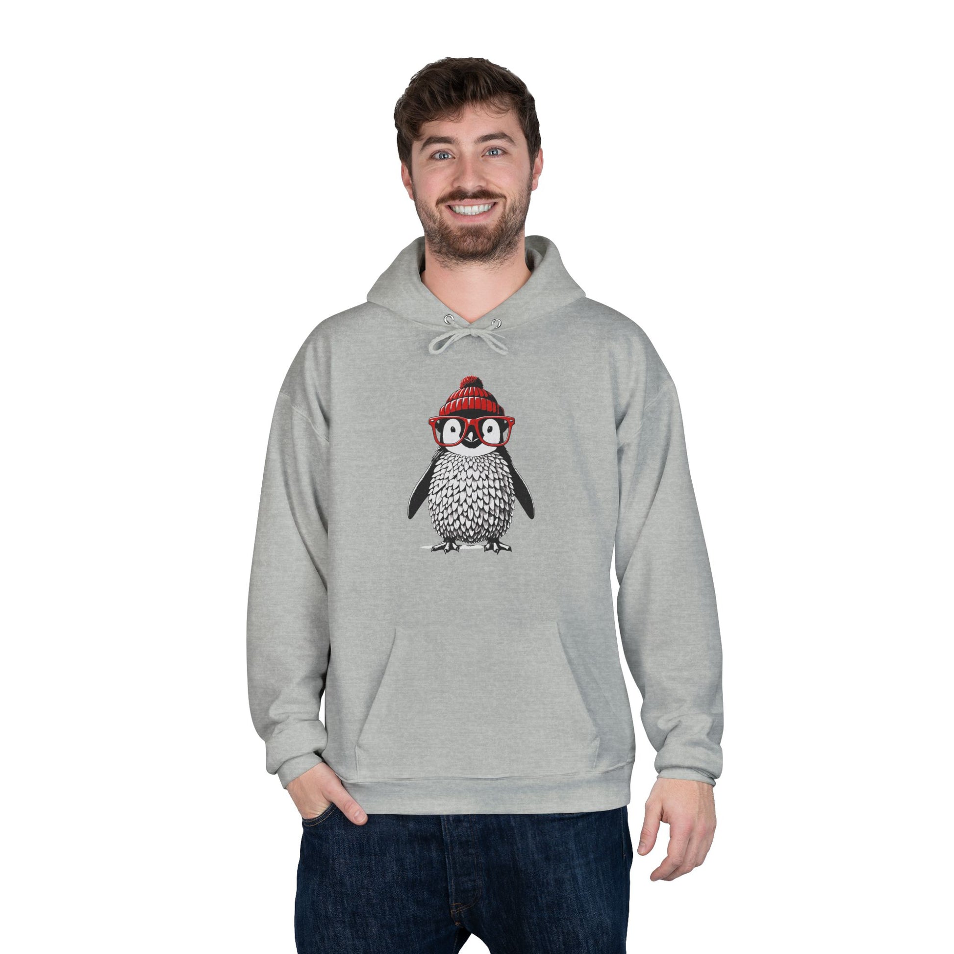 a man wearing a light steel colored hoodie with an image of a penguin wearing a red beanie and red eyeglasses