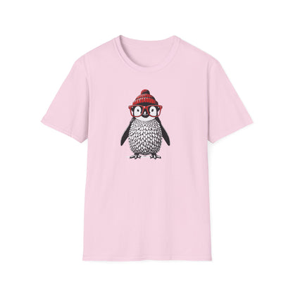 a light pink colored t-shirt with an image of a penguin wearing a red beanie and red eyeglasses