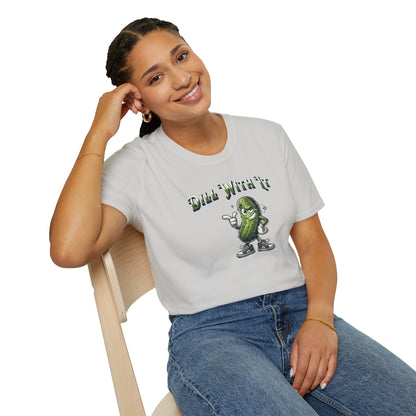 a woman wearing a ice grey colored t-shirt featuring a snarky pickle with a smirking expression, accompanied by the text 'Dill with it.' The pickle exudes cool confidence, perfect for those who embrace their individuality and unbothered attitude.