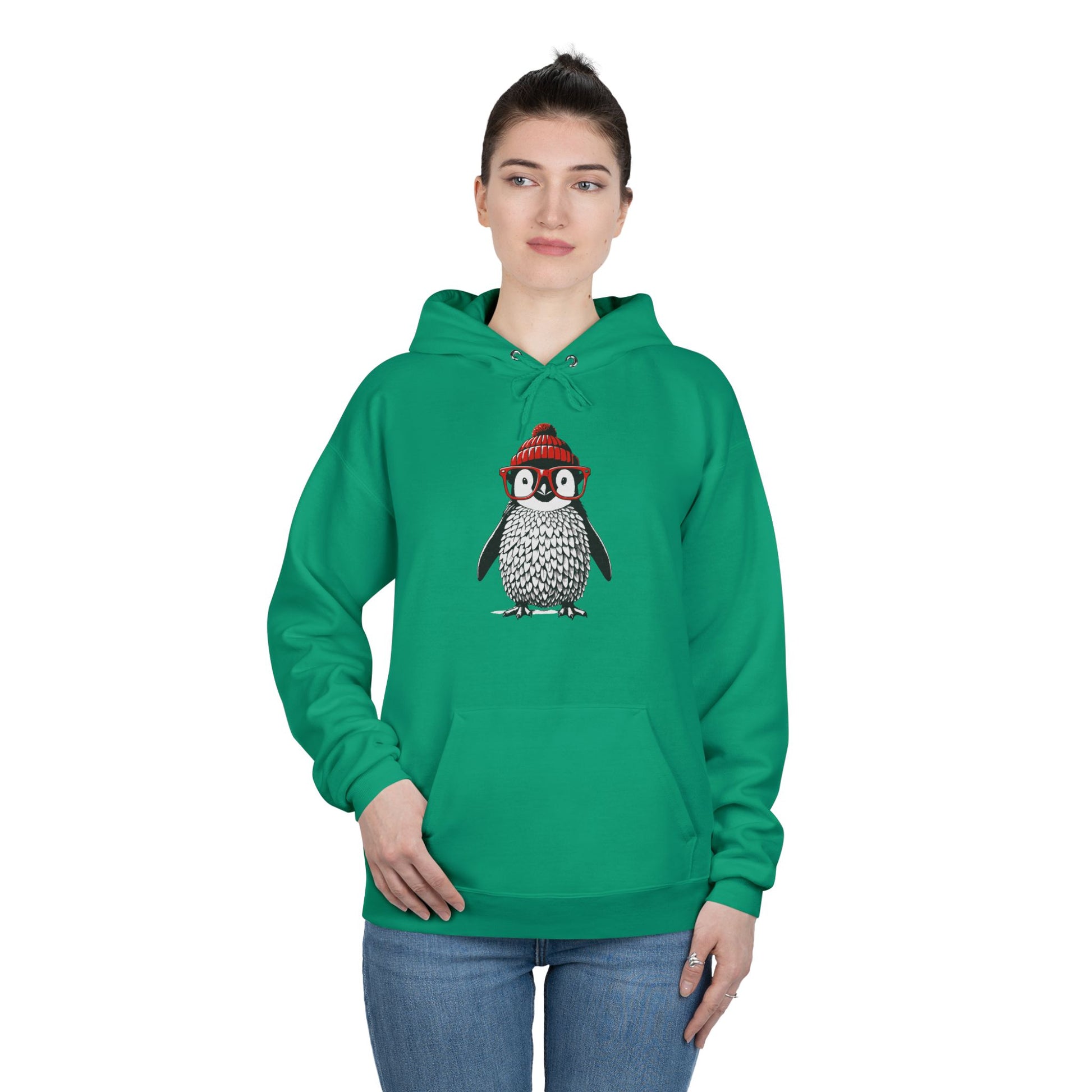 a woman wearing a kelly green colored hoodie with an image of a penguin wearing a red beanie and red eyeglasses