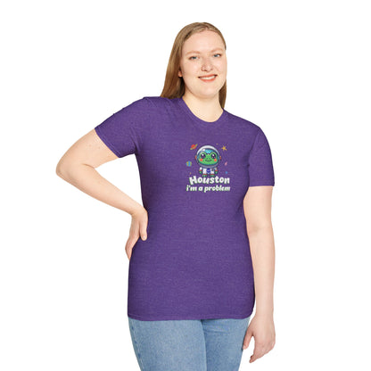 a woman wearing a heather purple colored t-shirt with graphic of a cute astronaut frog in a spacesuit, ready for an interstellar adventure. The design showcases the frog as a space cadet, radiating charm and joy, perfect for spreading smiles across the galaxy