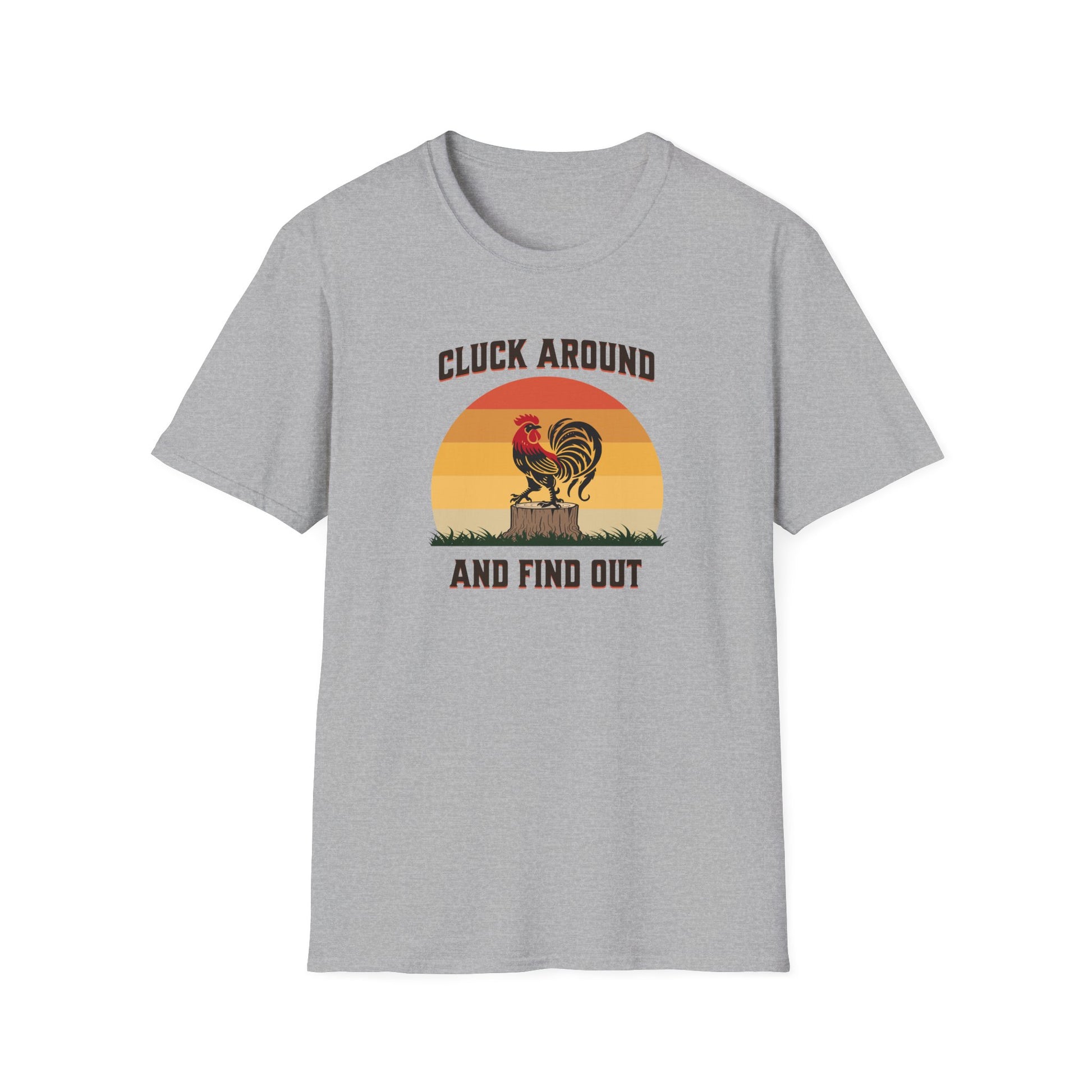 Sport grey colored t-shirt featuring a red and black rooster standing on a brown tree stump on green grass, set against a retro red-to-orange sunset background with the text 'Cluck Around and Find Out'.