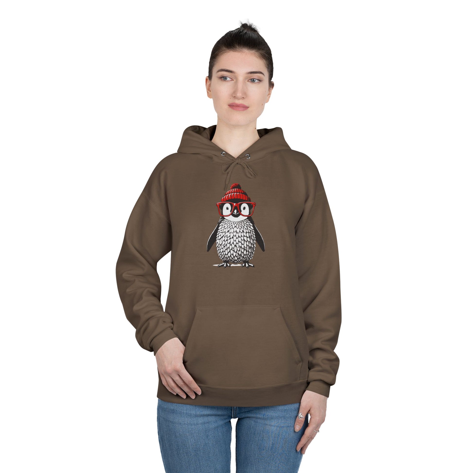 a woman wearing an army brown colored hoodie with an image of a penguin wearing a red beanie and red eyeglasses