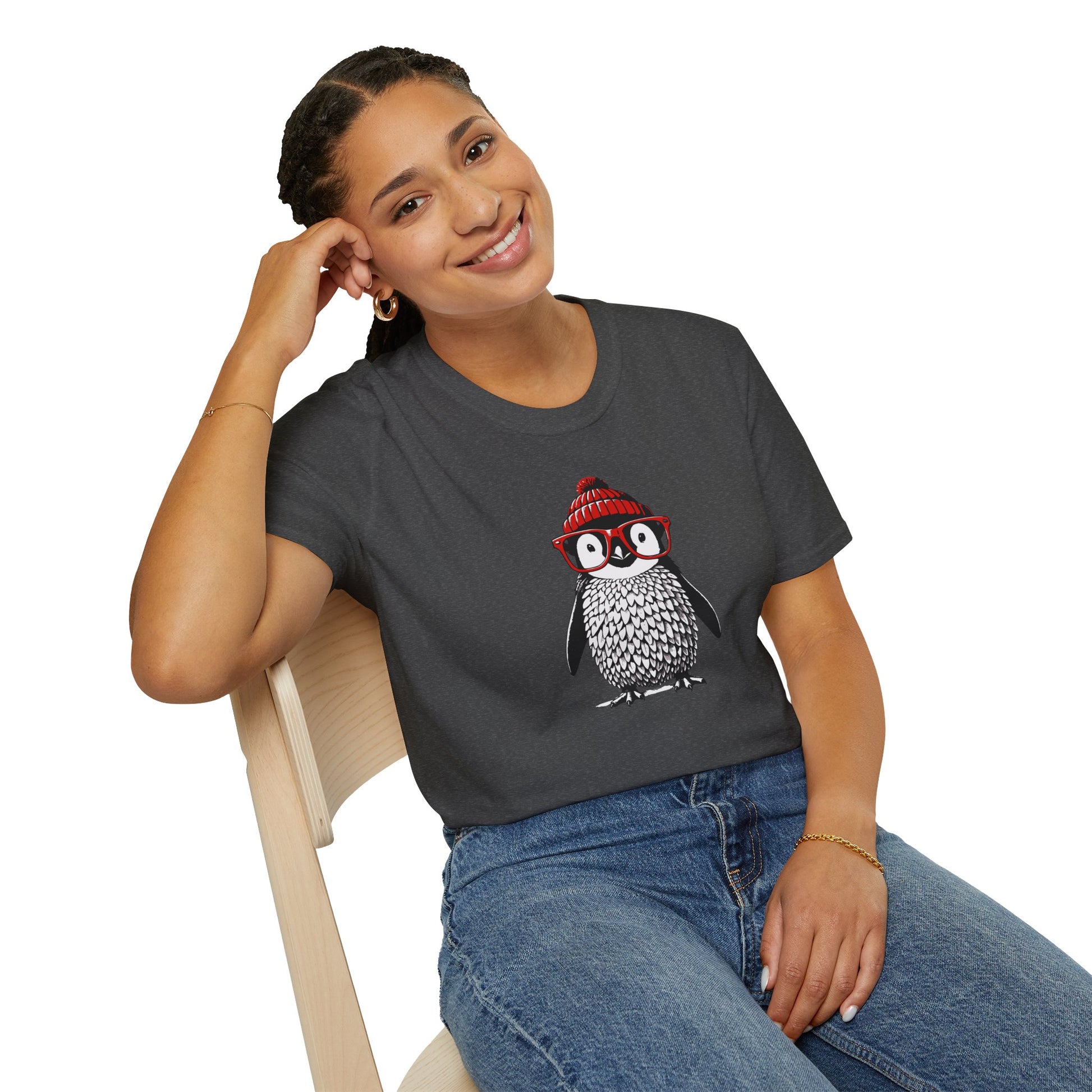 a woman wearing a dark heather colored t-shirt with an image of a penguin wearing a red beanie and red eyeglasses