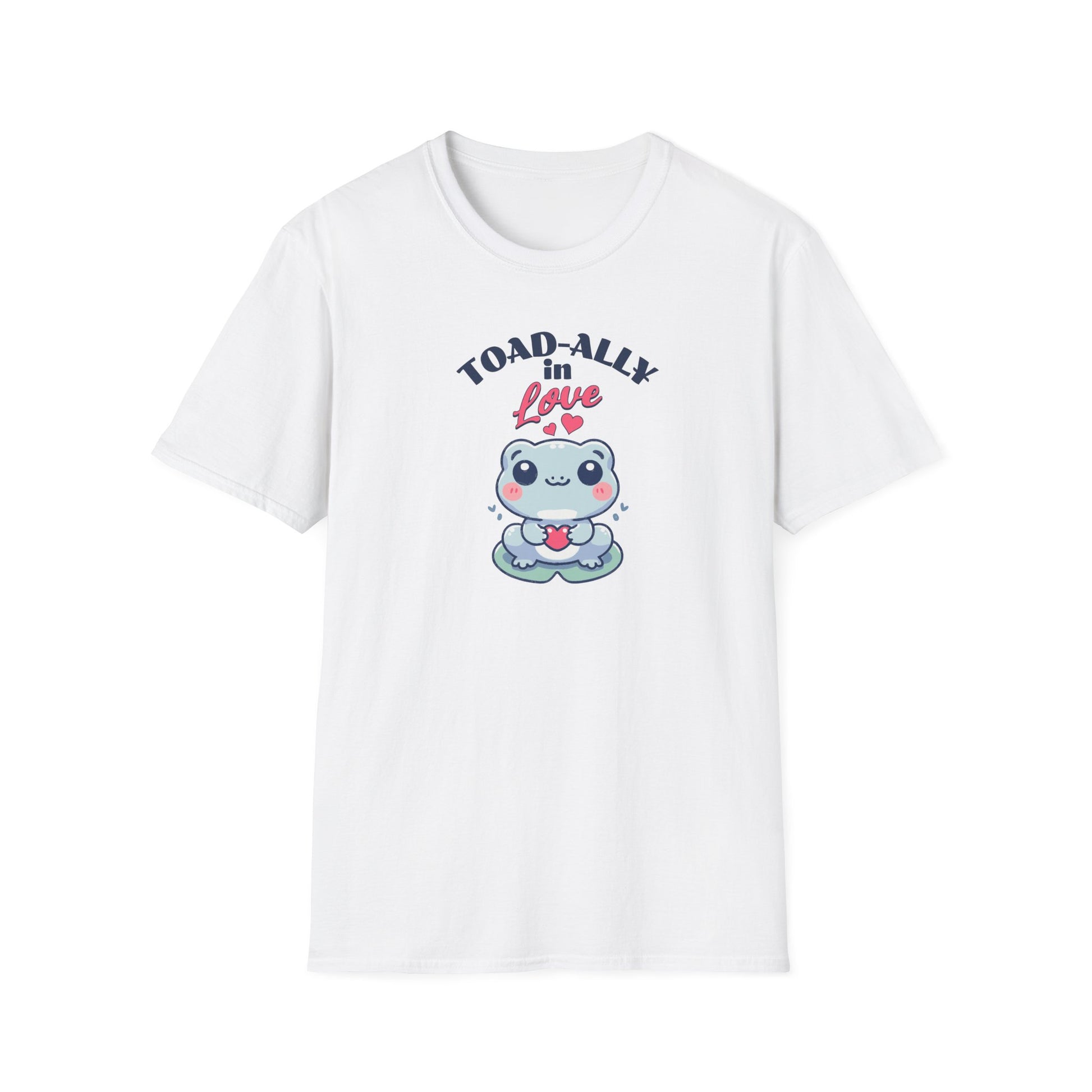 a cartoonish blue frog with a cheerful expression holds a small red heart in its hands. The design is printed on a white T-shirt and features the playful phrase 'Leap into Love!' adding a charming and romantic vibe.