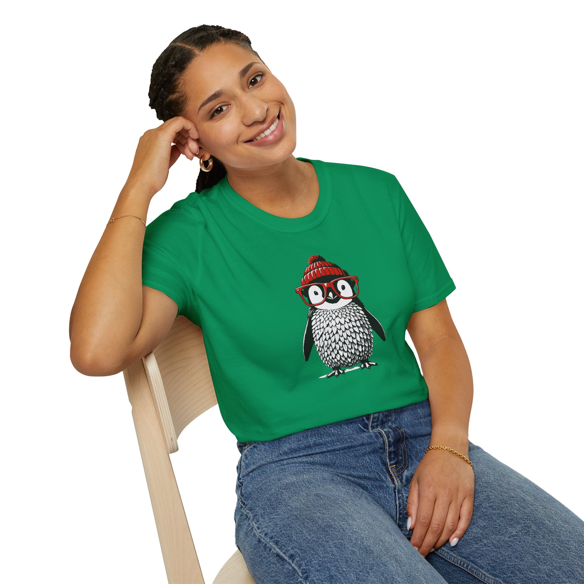 a woman wearing a Kelly green colored t-shirt with an image of a penguin wearing a red beanie and red eyeglasses