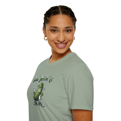 a woman wearing a sage colored t-shirt featuring a snarky pickle with a smirking expression, accompanied by the text 'Dill with it.' The pickle exudes cool confidence, perfect for those who embrace their individuality and unbothered attitude.