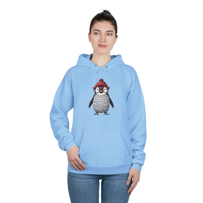 a woman wearing a light blue colored hoodie with an image of a penguin wearing a red beanie and red eyeglasses