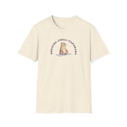 a sand colored t-shirt with a capybara in a yoga pose sitting on a yoga mat with the text 'breathe, chill, capybara'.