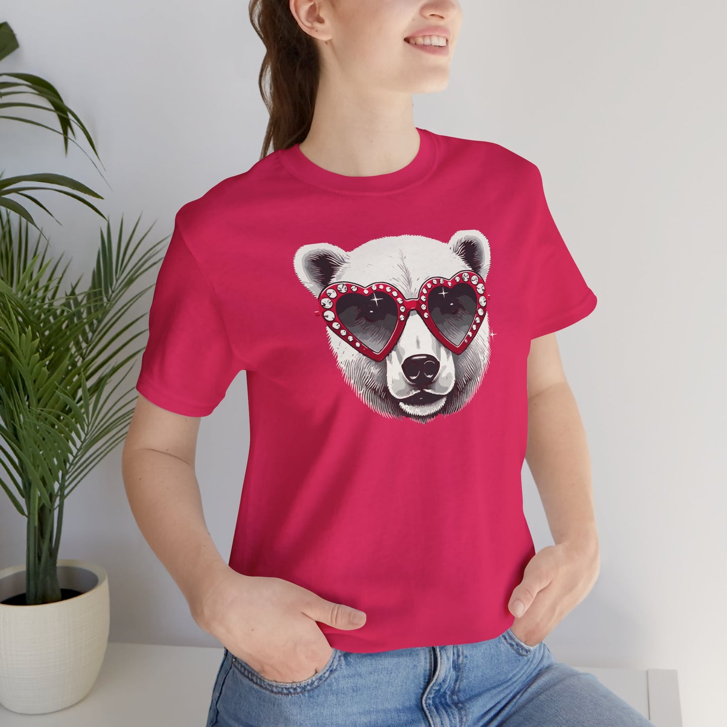 a woman wearing a fuchsia color t-shirt with a white polar bear face wearing a a heart-shaped sunglasses 