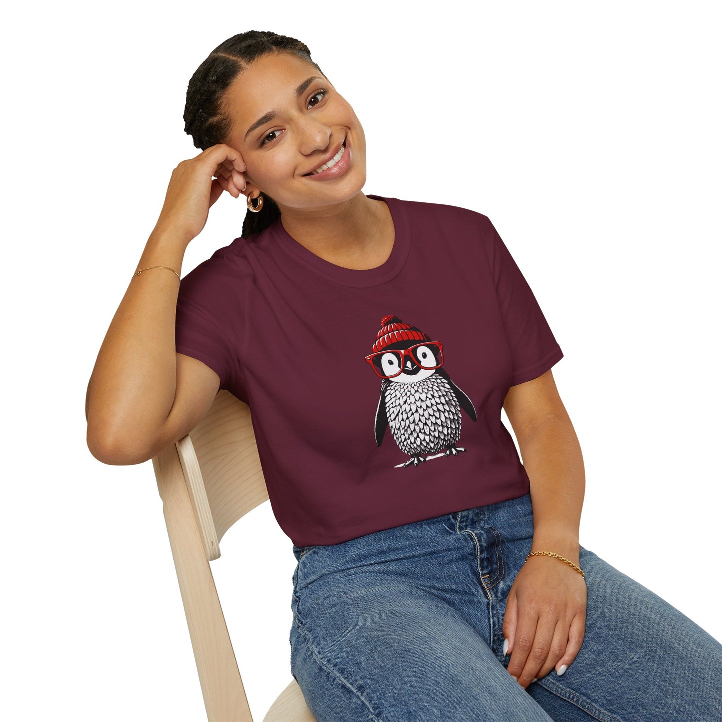 a woman wearing a maroon colored t-shirt with an image of a penguin wearing a red beanie and red eyeglasses