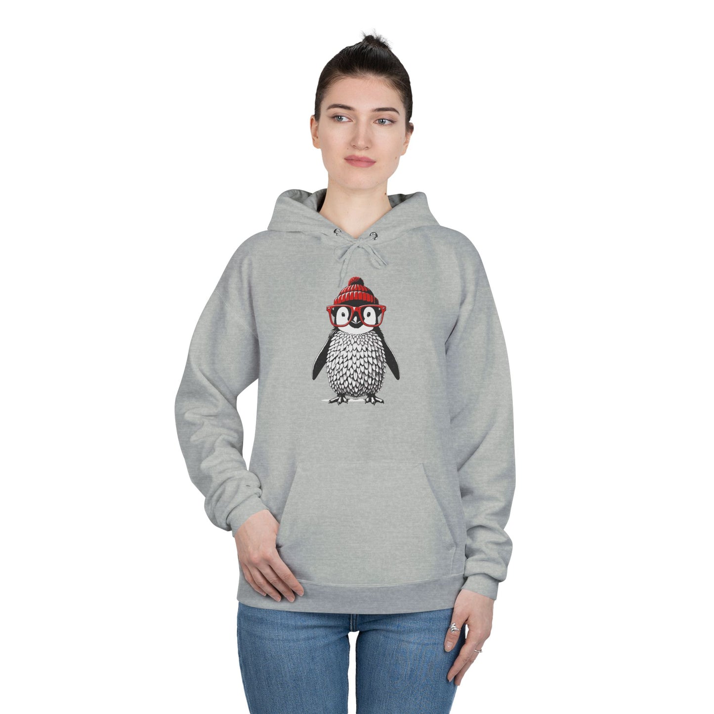 a woman wearing a light steel colored hoodie with an image of a penguin wearing a red beanie and red eyeglasses