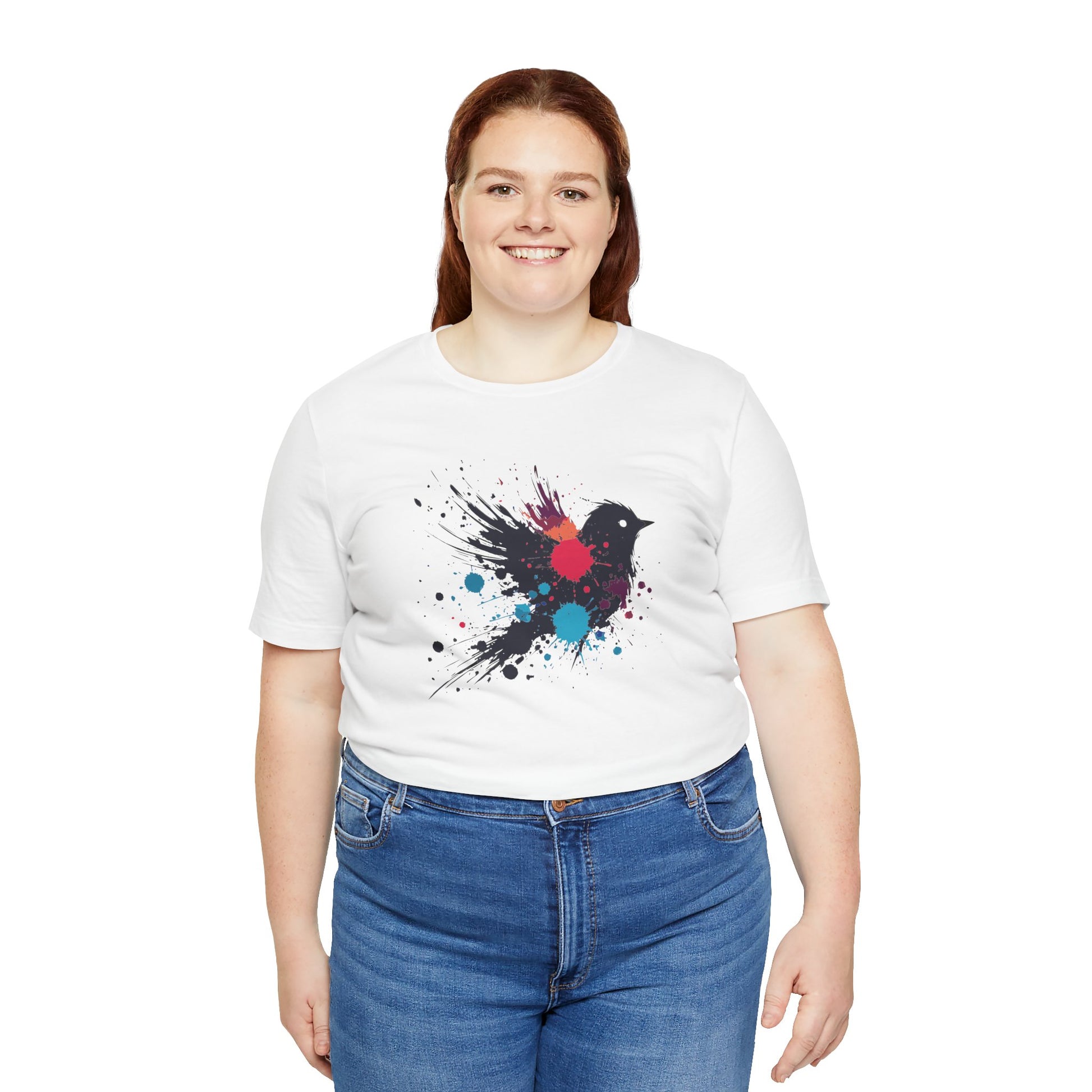 a woman wearing a white color t-shirt with an image of blue red and orange paint splatter bird